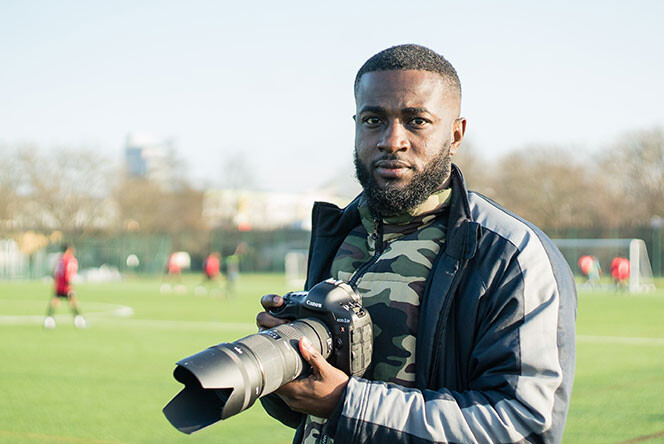 Hugues Mfumu holding a camera.