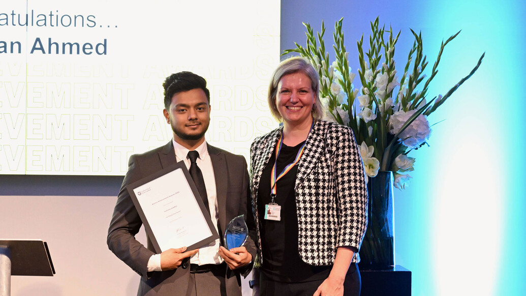 Farhan Ishraque Ahmed collects his award from Vanessa Varvas, UEL's Chief Marketing Officer
