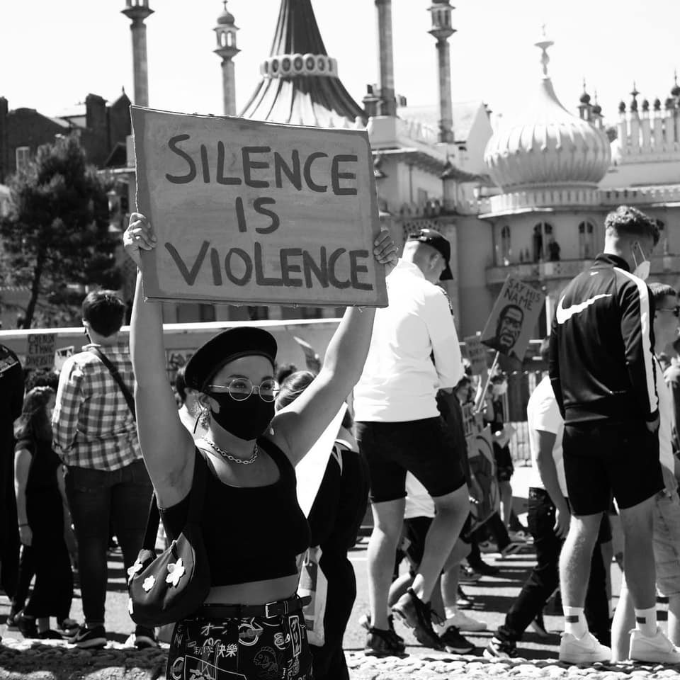 Mia Cunningham at the BLM protests with a "Silence is violence" picket.