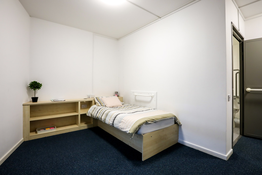 A wheelchair accessible room in halls of residence showing bed and desk area