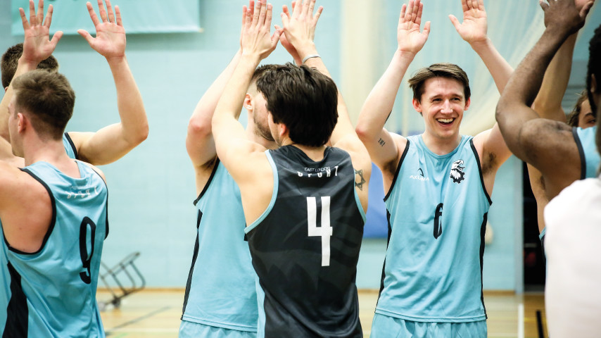 Volleyball players high-fiving each other.