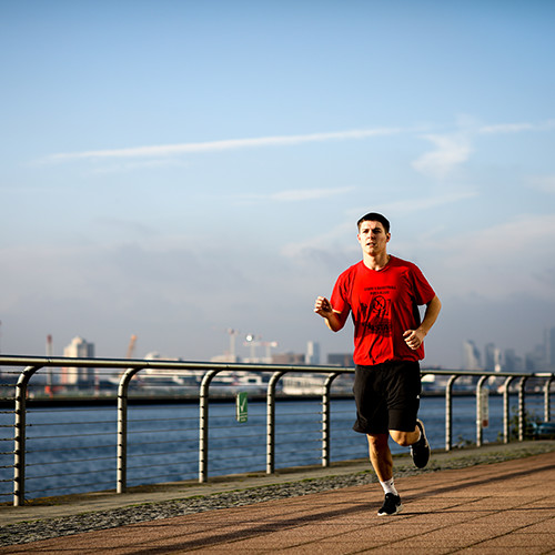 Runner exercising by the river