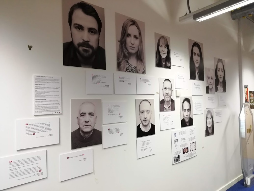 Photos of different people on a wall surrounded by blocks of text