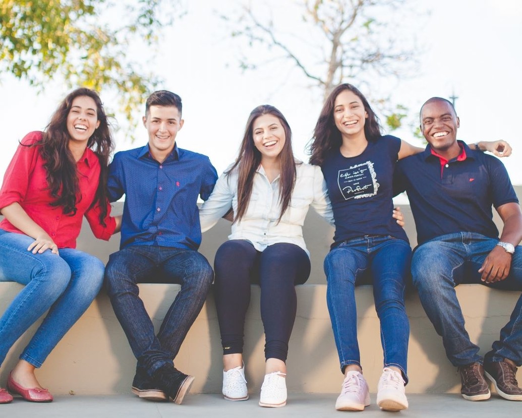 A group of students sitting together smiling