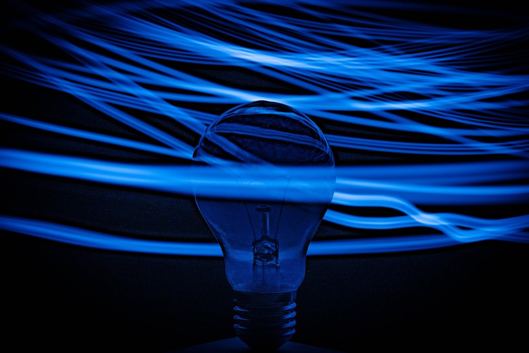 Blue lightbulb behind some wires