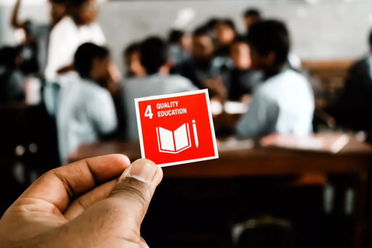 Hand holding sustainable development goal note
